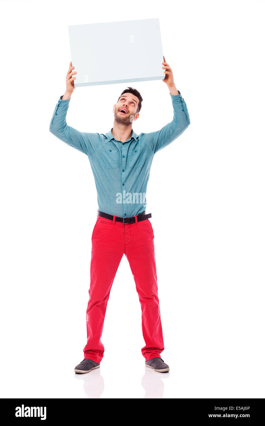 Happy man holding a blank sign overhead, Debica, Poland Stock Photo