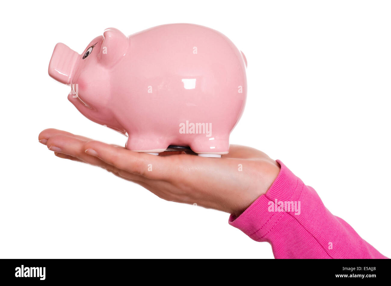 Female hand is holding a pink piggy bank Stock Photo - Alamy