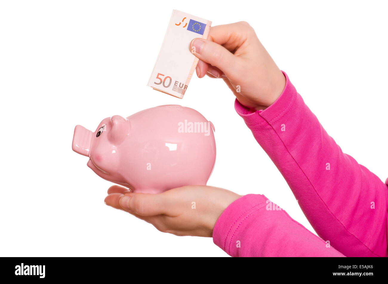 Female hand is putting a euro not into a pink piggy bank Stock Photo ...