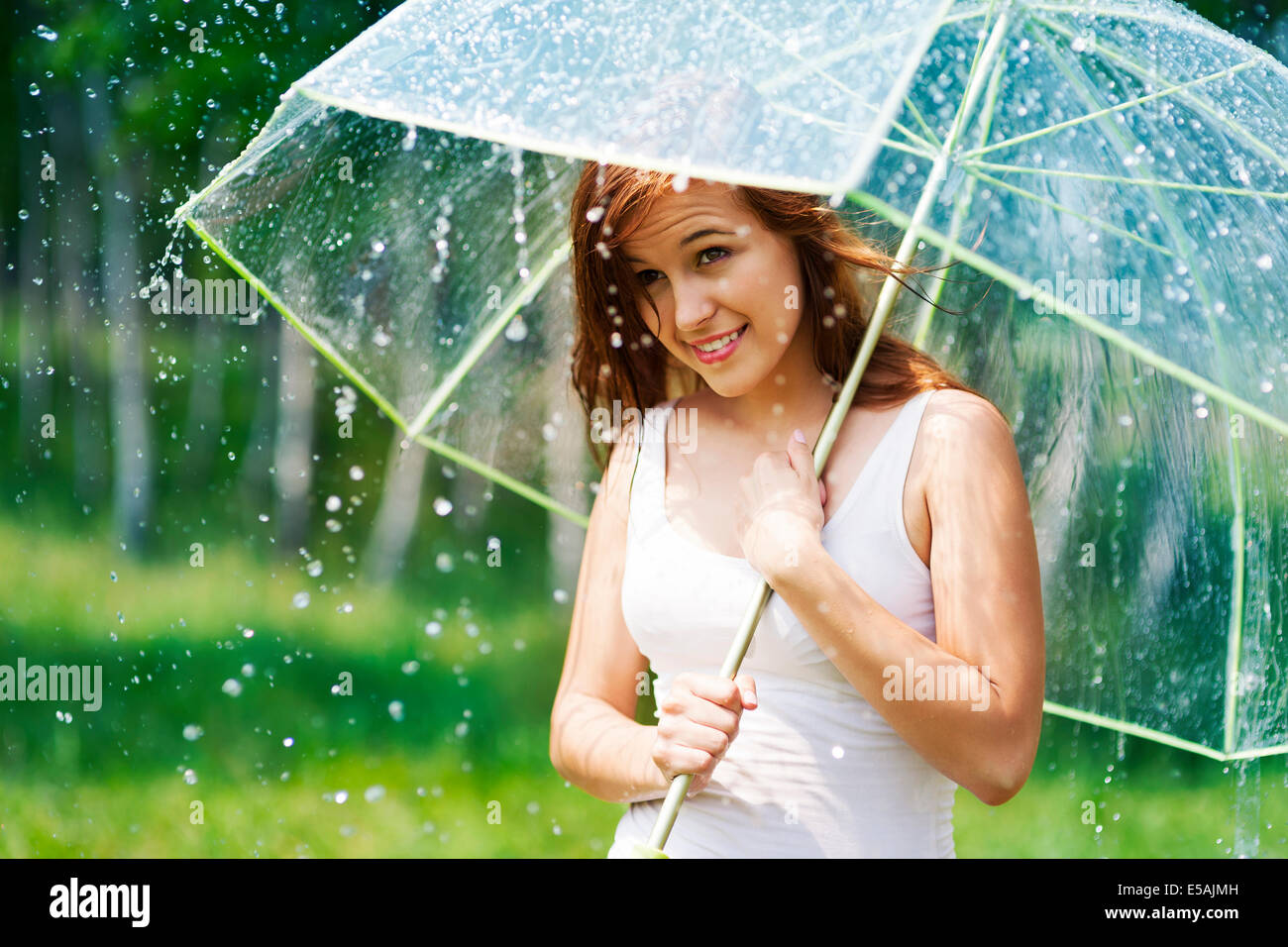 Beautiful woman with umbrella during the rain, Debica, Poland Stock Photo