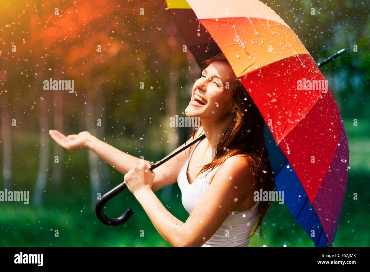 Laughing woman with umbrella checking for rain, Debica, Poland Stock Photo