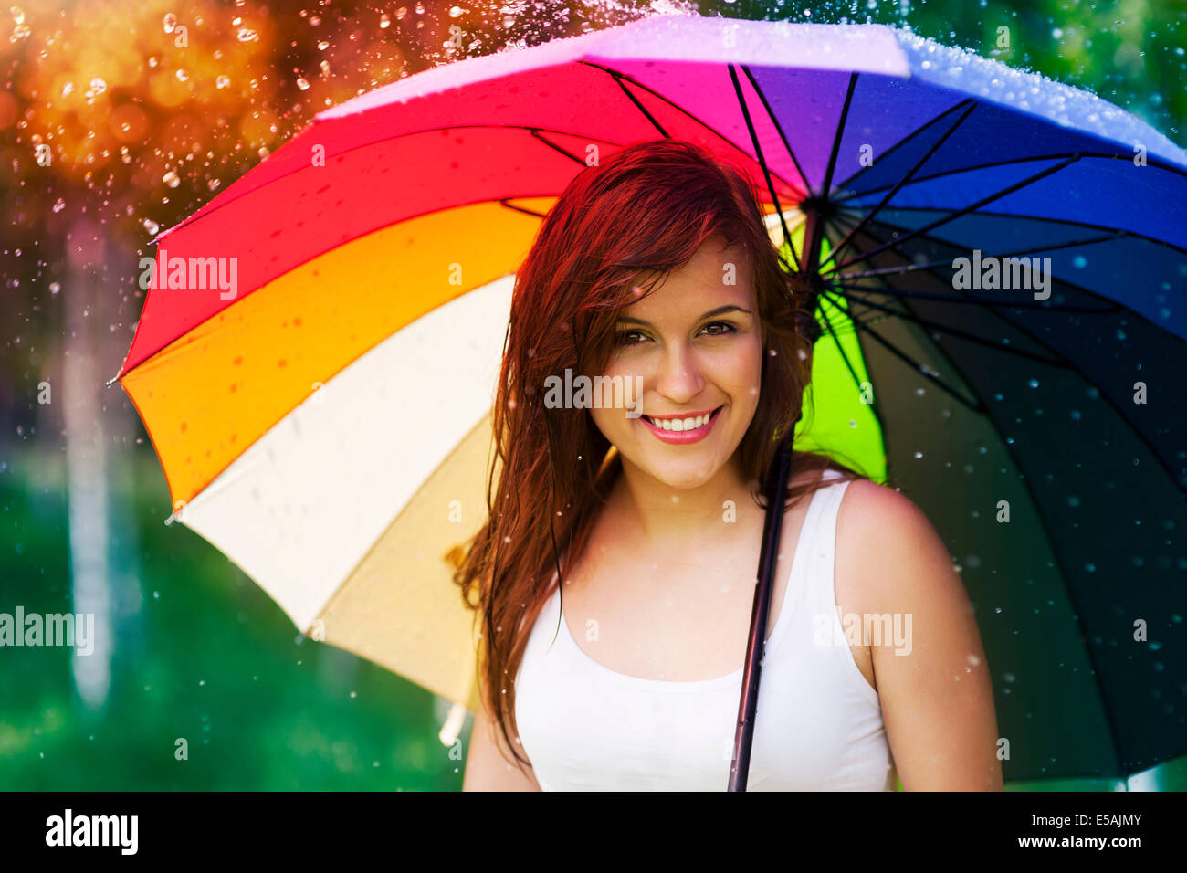Portrait of beautiful and smiling woman with umbrella, Debica, Poland. Stock Photo