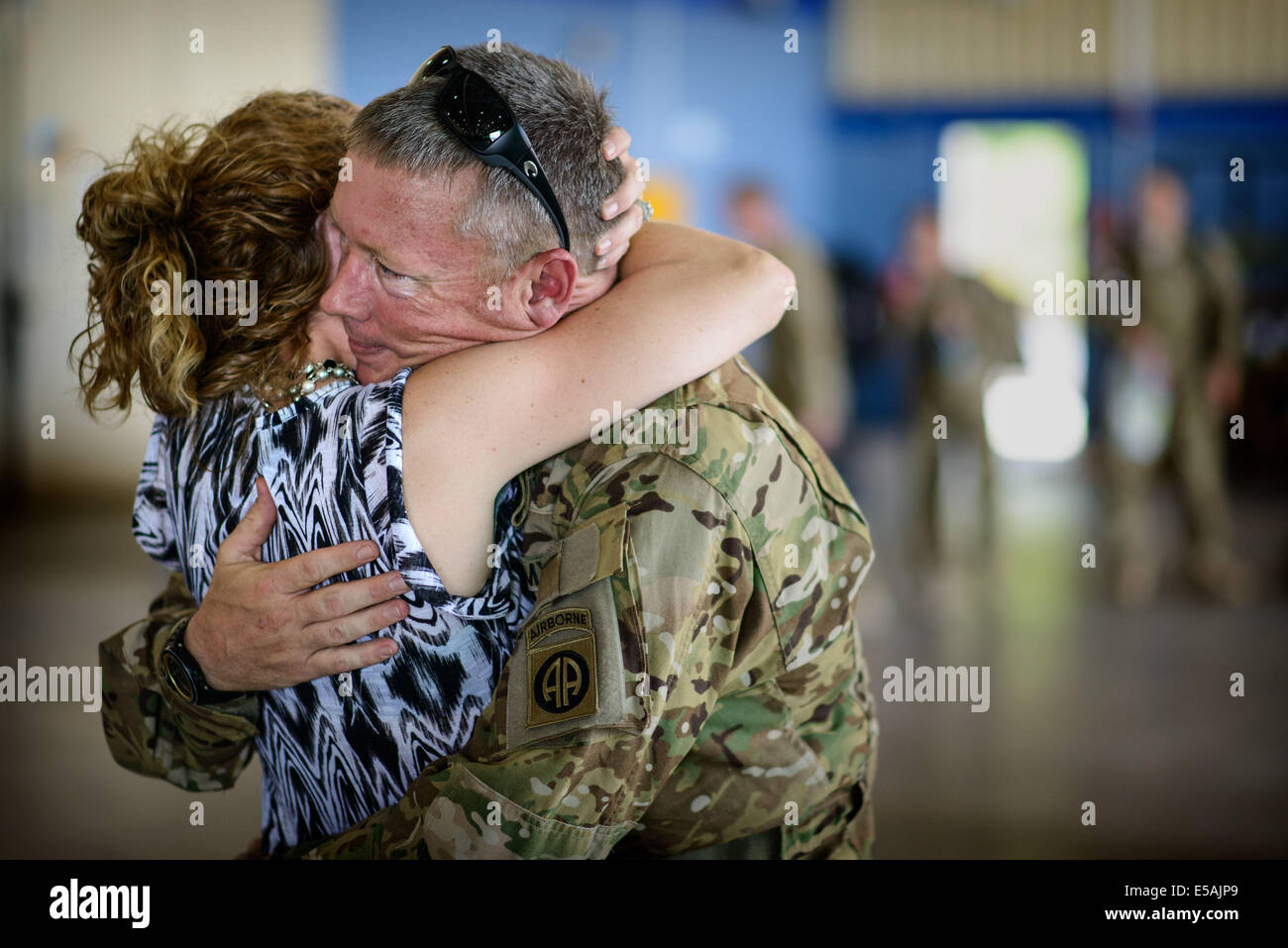 July 24, 2014 - Fort Bragg, NC, USA - July 24, 2014 - Fort Bragg, N.C., USA - Chief Warrant Officer Charles Ray hugs his wife, Jamie, Thursday, July 24, 2014, on Fort Bragg, N.C., before he and his fellow soldiers from Company C, 3rd General Support Aviation Battalion, 82nd Combat Aviation Brigade, deploy to Afghanistan for nine months. (Credit Image: © Andrew Craft/ZUMA Wire/ZUMAPRESS.com) Stock Photo