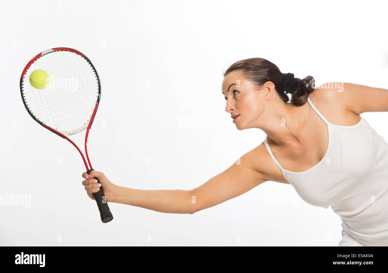 Female tennis player stretching to hit the ball Stock Photo Alamy