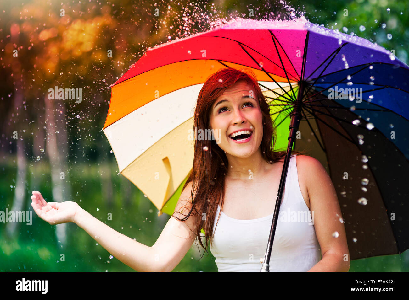 Surprised woman with umbrella during summer rain, Debica, Poland Stock Photo