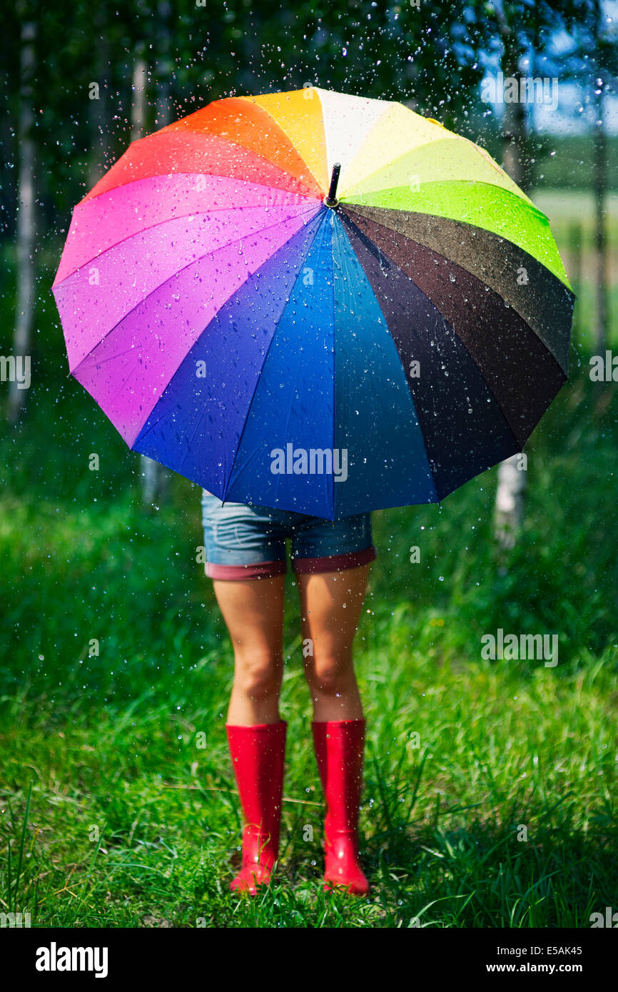 Woman protecting herself from the rain, Debica, Poland. Stock Photo