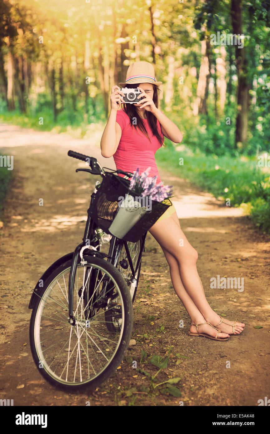 Young woman on bike photographing nature, Debica, Poland. Stock Photo