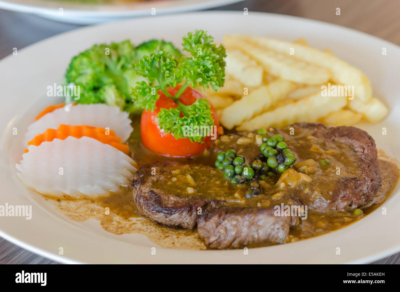 close up beef steak with green peppercorn sauce Stock Photo Alamy