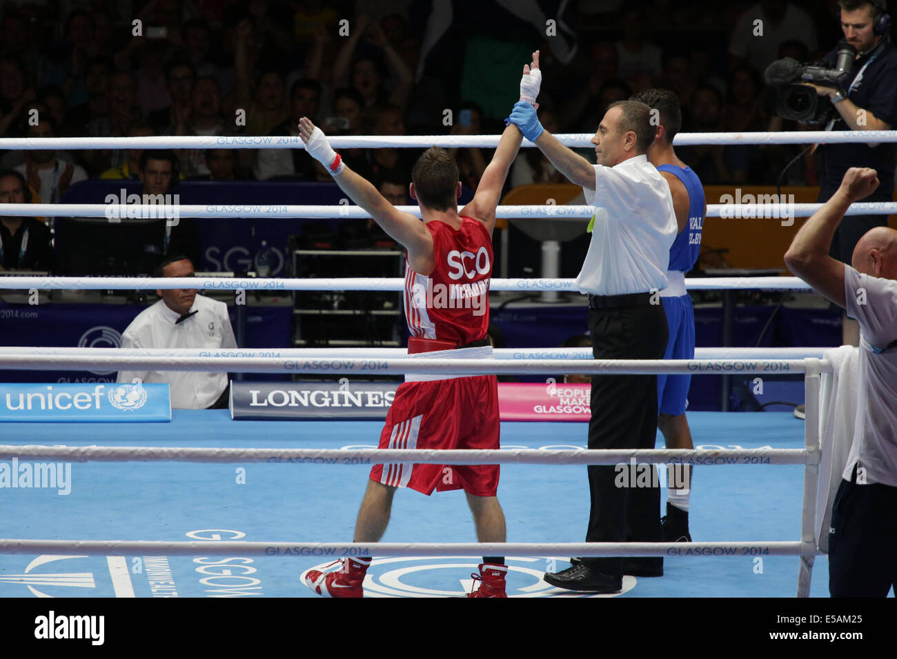 SECC, Glasgow, Scotland, UK, Friday, 25th July, 2014. Flyweight 52kg Preliminary Boxing Match. Reece McFadden of Scotland in red declared the winner in his bout against Andrew Selby of Wales in blue at the Glasgow 2014 Commonwealth Games Stock Photo