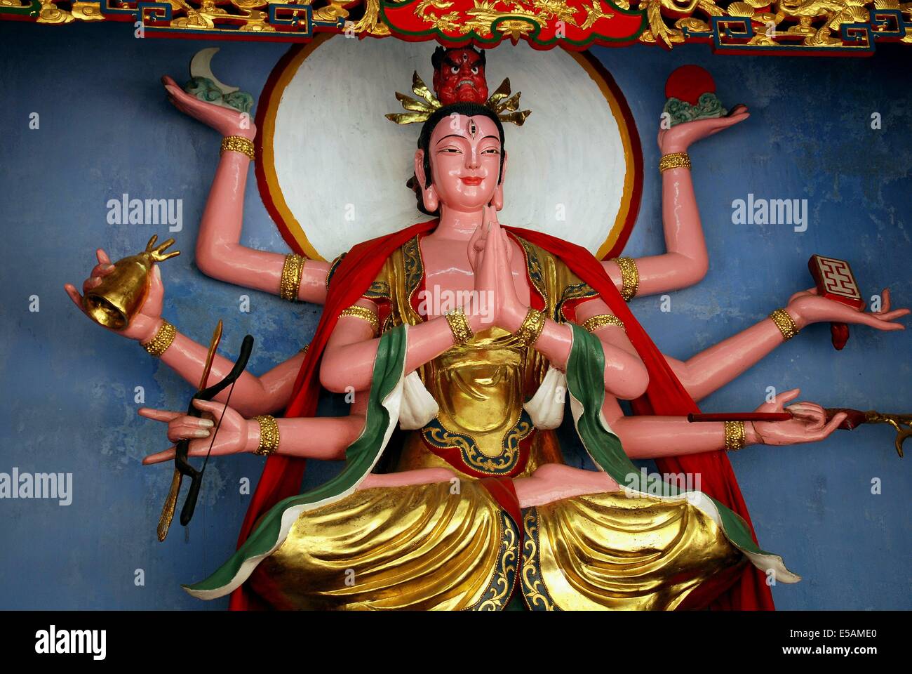 MT. QINGCHENG, CHINA BUDDHA FIGURE WITH MULTIPLE ARMS HOLDING RELIGIOUS SYMBOLS AT THE HISTORIC