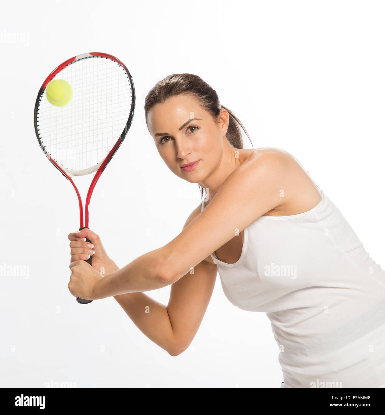 Attractive female tennis player holding the racquet with two hands Stock  Photo - Alamy