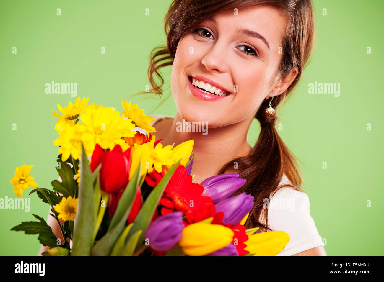 Happy young woman with flowers, Debica, Poland Stock Photo