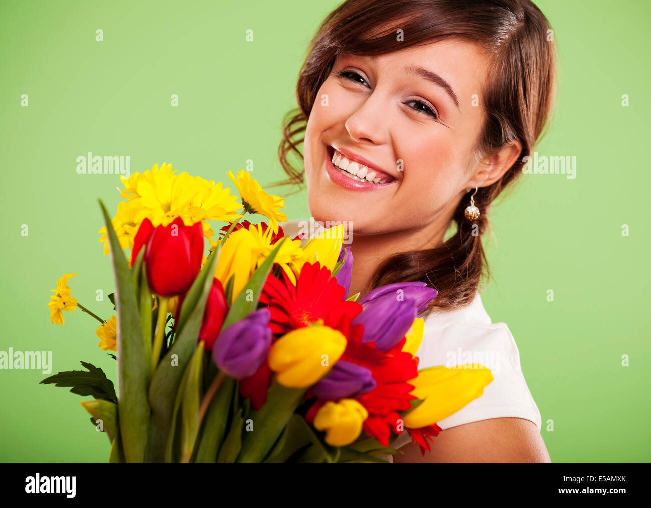 Portrait of a smiling woman with colorful flowers, Debica, Poland Debica, Poland Stock Photo