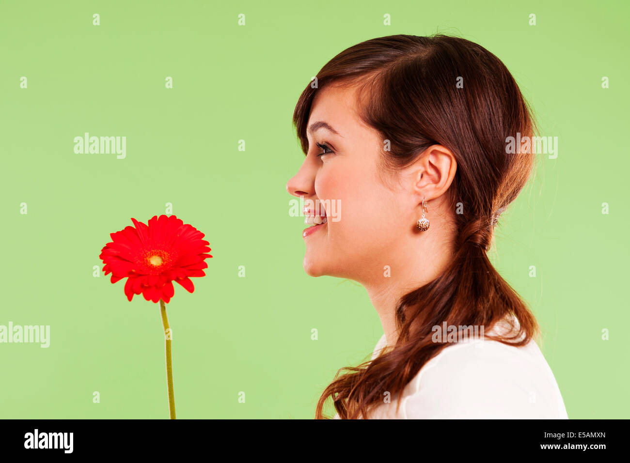 Pretty woman holding red flower, Debica, Poland Stock Photo