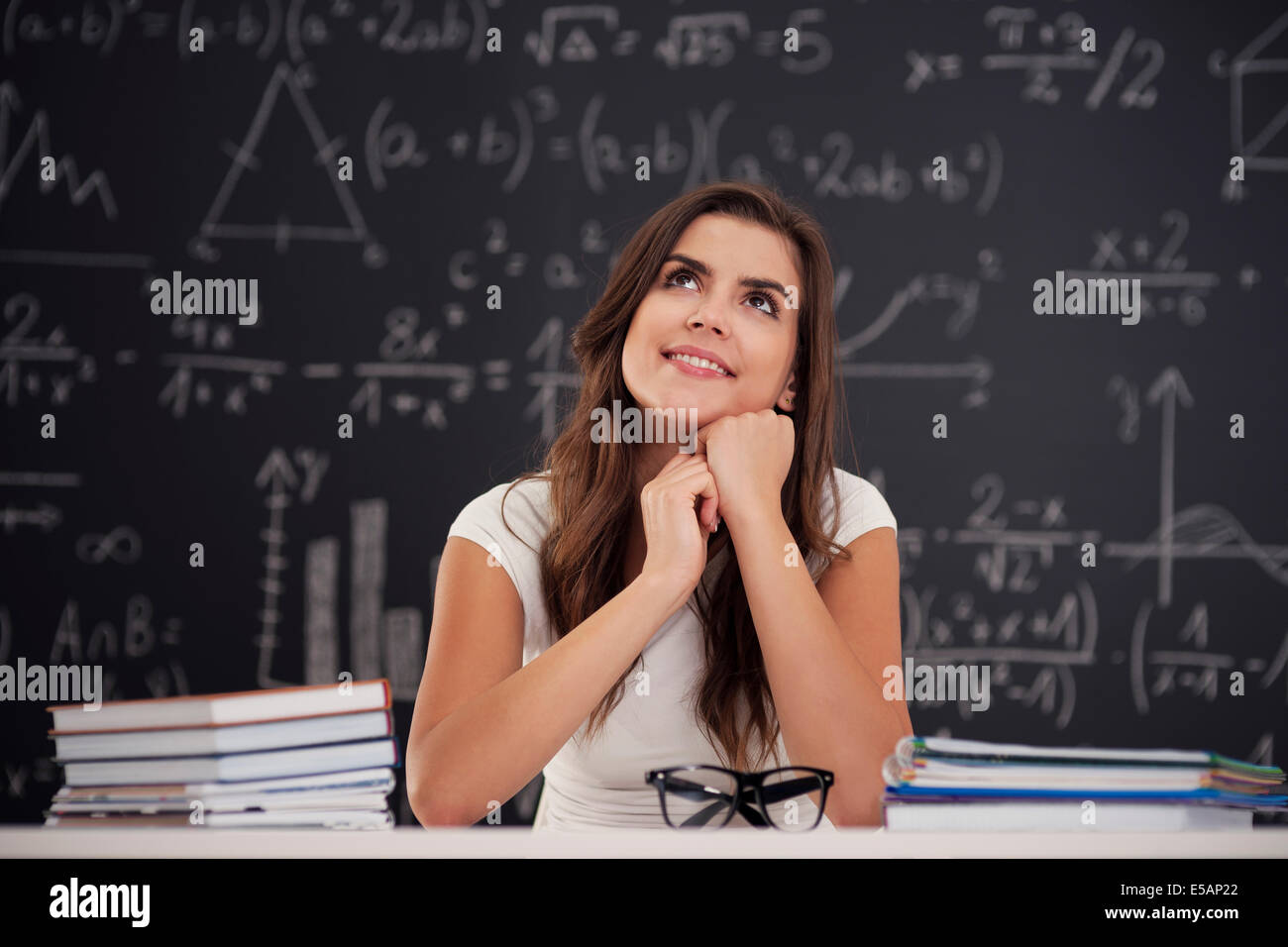 Happy woman sitting in classroom and looking up Debica, Poland Stock ...