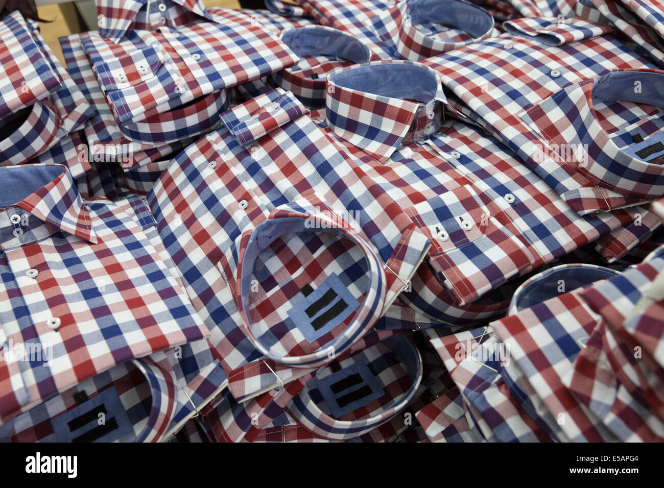 shirts in the production process stacked on a pile Stock Photo