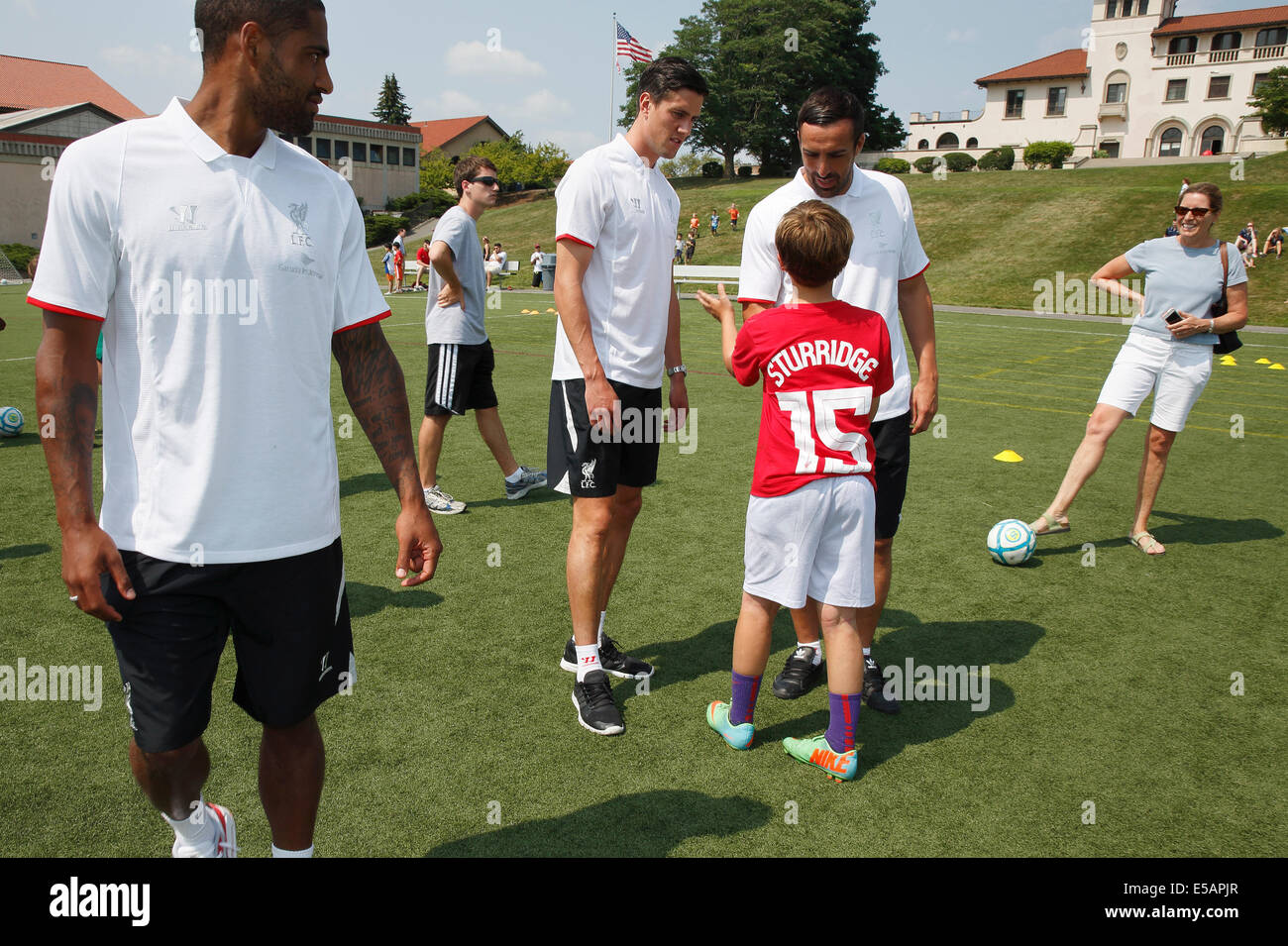 Brookline, Massachusetts, USA,  25th July, 2014. Liverpool defenders, from left, Glen Johnson, Martin Kelly and Jose Enrique visit a football day camp at the Dexter Southfield School in Brookline, Massachusetts, Friday, July 25, 2014. The club is currently on a pre-season tour of the US. Stock Photo
