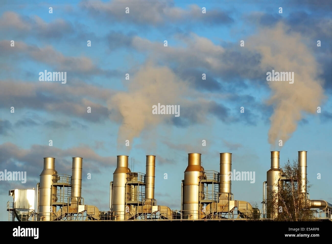 smoke from chimneys on a blue sky Stock Photo - Alamy