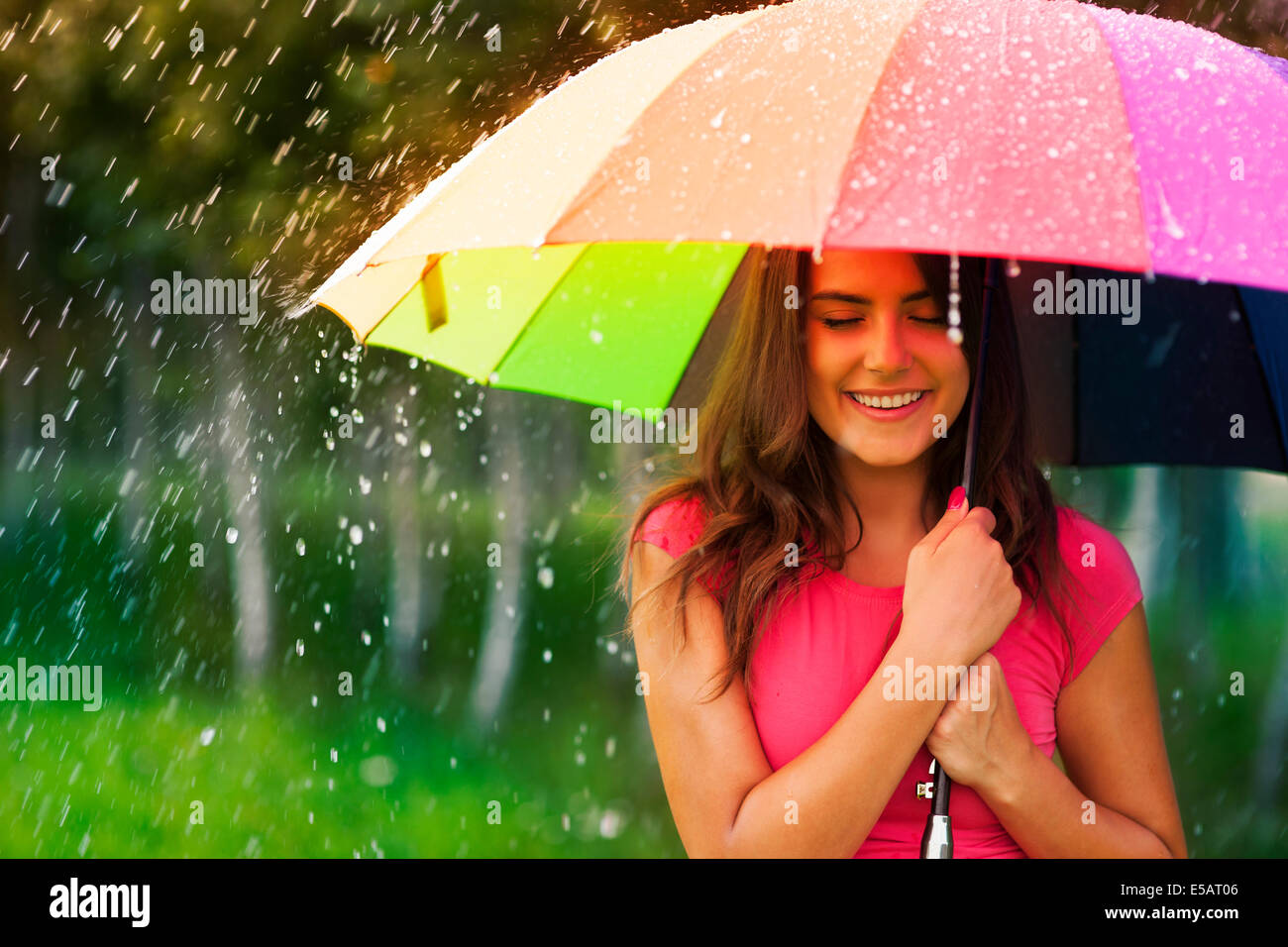 Beautiful woman under rainbow umbrella Debica, Poland Stock Photo