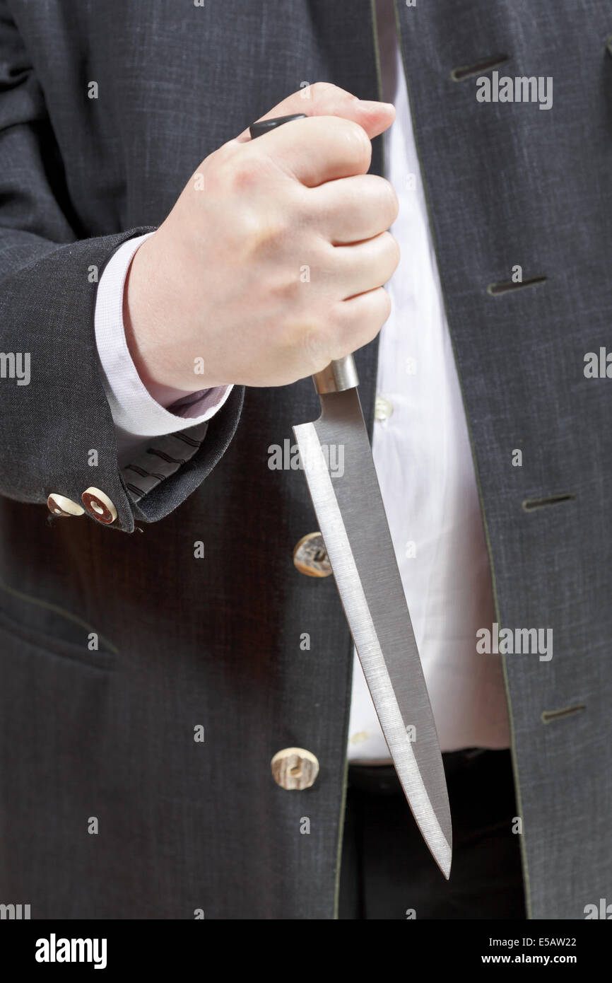 front view of knife in businessman hand close up Stock Photo