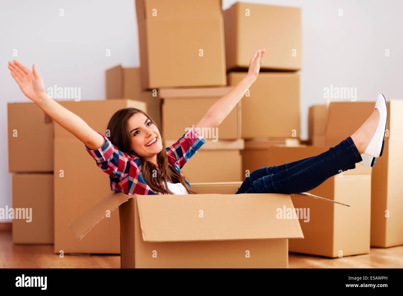 Cheerful woman sitting in a cardboard box Debica, Poland Stock Photo ...