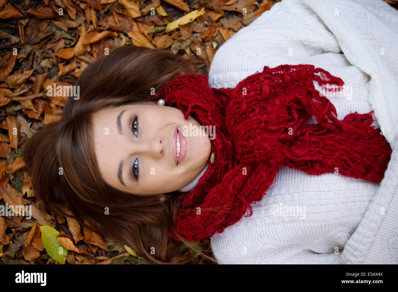 Beauty girl lying down on leaves Debica, Poland Stock Photo