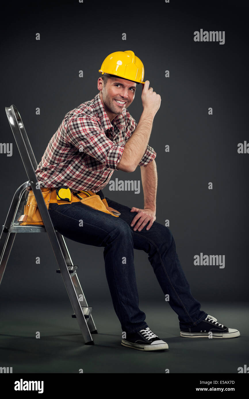 Construction worker sitting on a ladder Debica, Poland Stock Photo Alamy