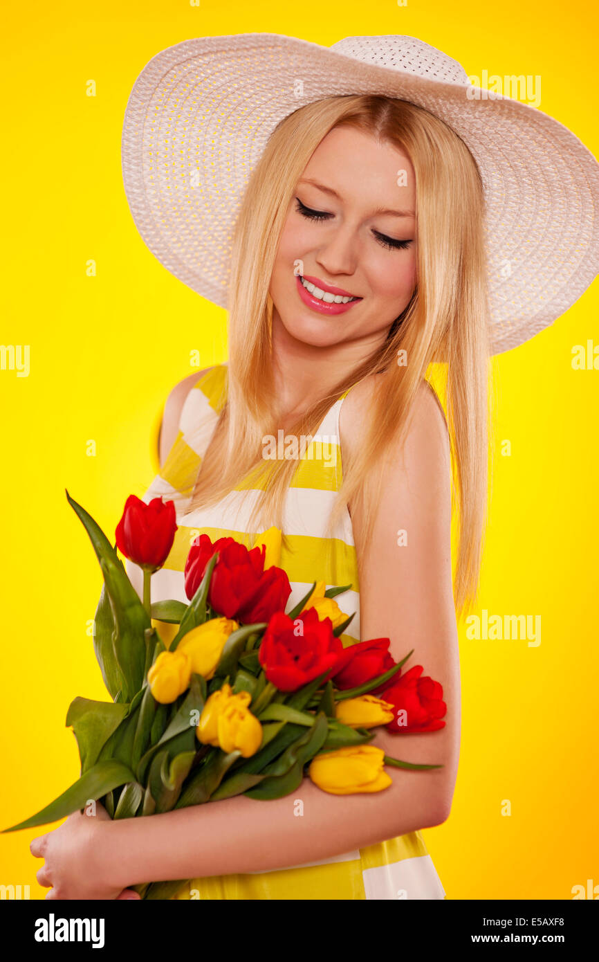 Spring portrait of a beautiful young woman with tulips Debica, Poland Stock Photo