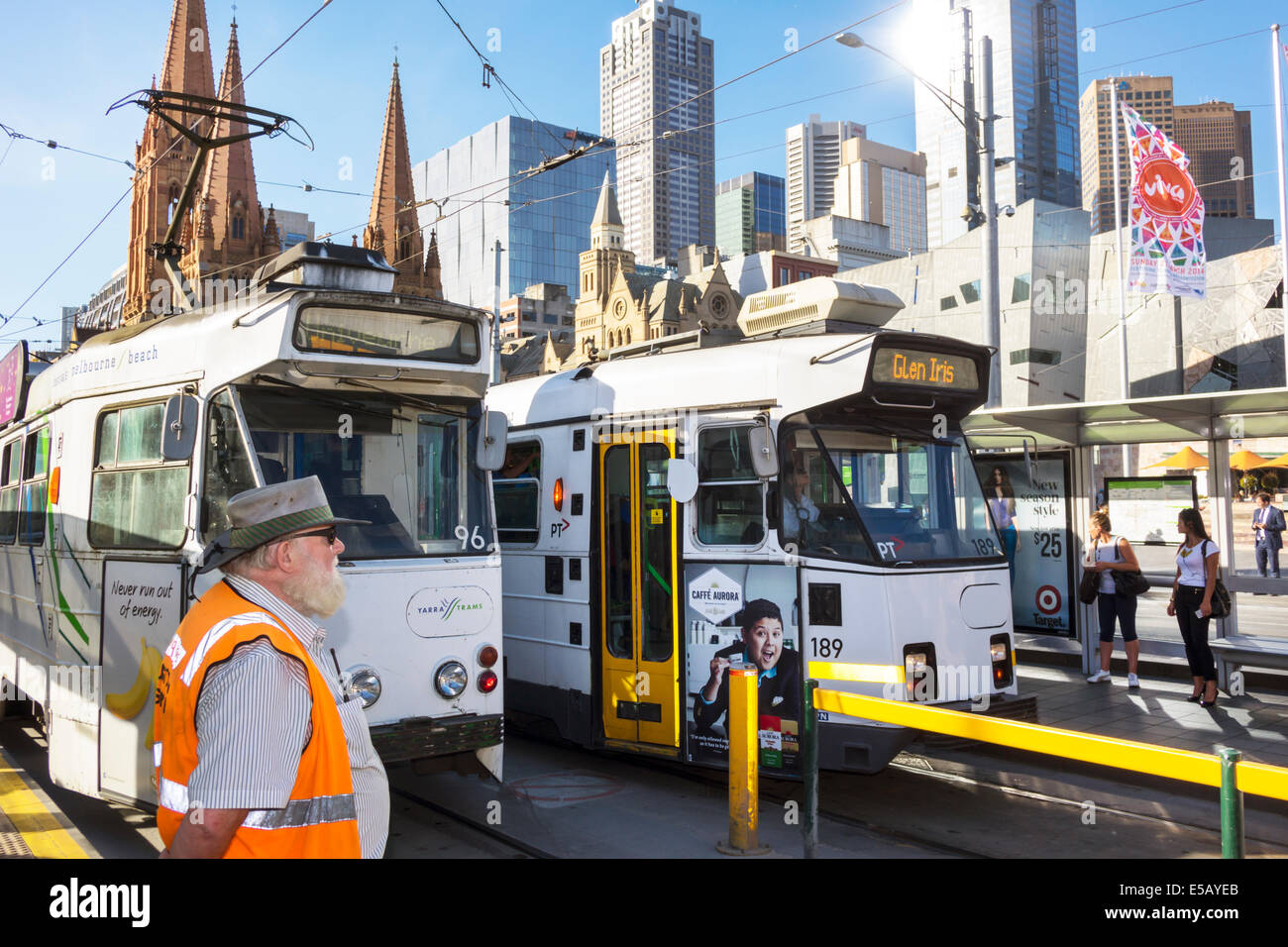 Melbourne Australia,Federation Square,St. Kilda Road,tram,trolley,city skyline,skyscrapers,high rise,buildings,St. Paul's Cathedral,man men male,safet Stock Photo