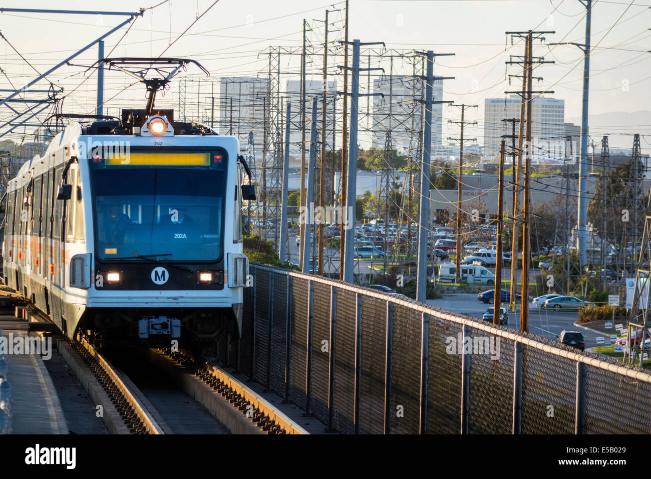 Los Angeles California,LA County Metro Rail,rail,mass transit,train,pantograph,power lines,poles,skyline,approaching,Redondo Beach Station,CA140401084 Stock Photo