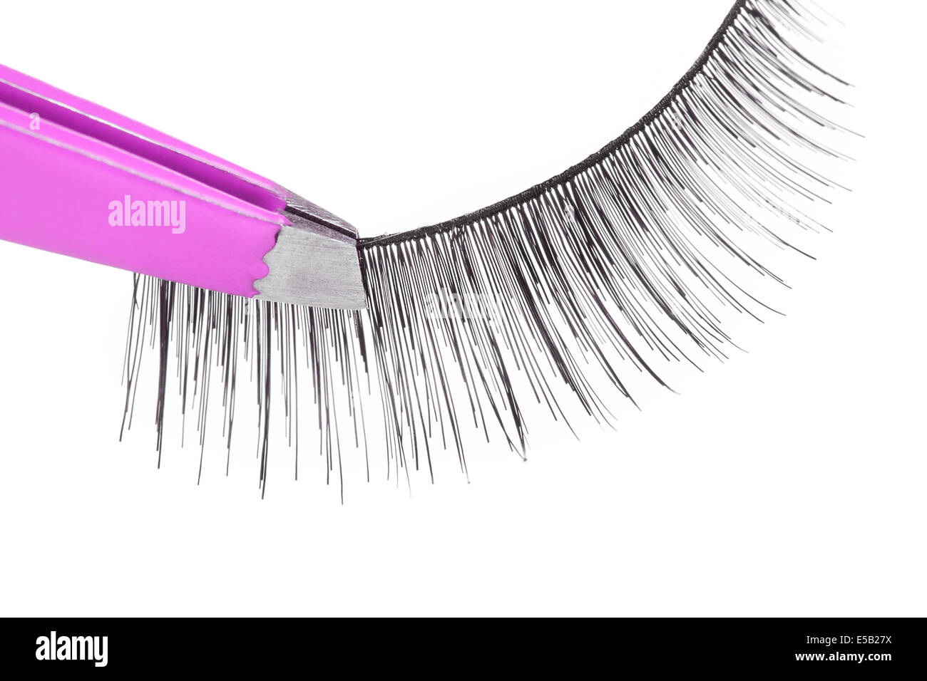 False lashes and pink pincers, closeup on white background Stock Photo