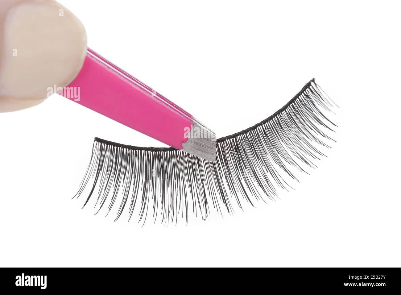 False lashes and pink pincers, closeup on white background Stock Photo