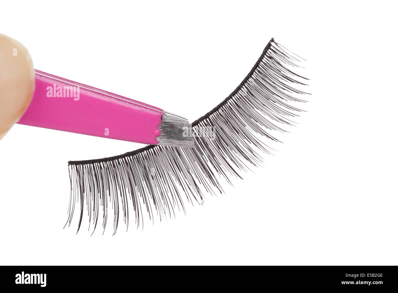 False lashes and pink pincers, closeup on white background Stock Photo