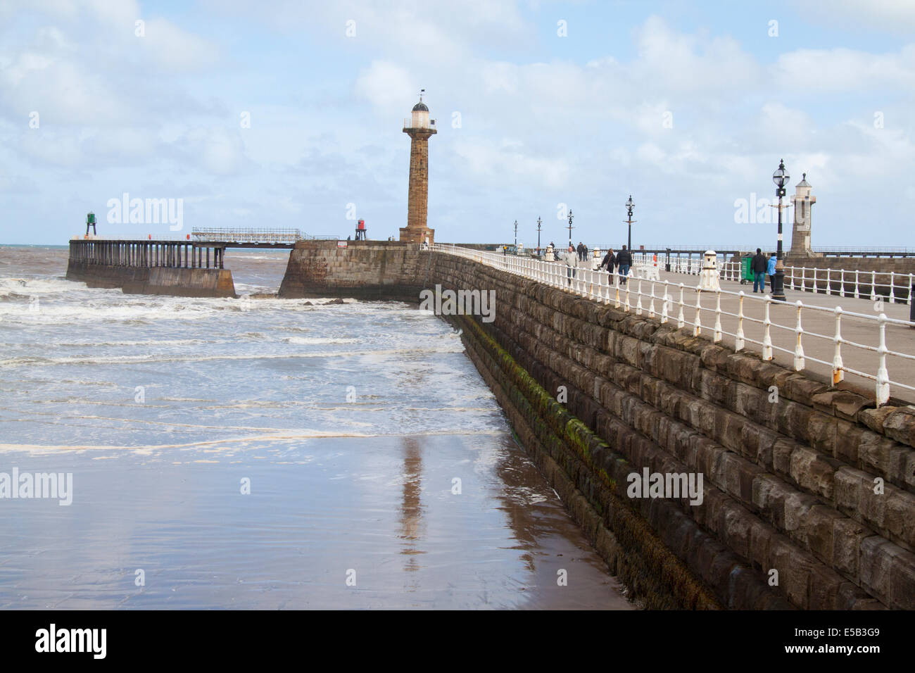 View of the sea at Whitby showing the pier and lighthouse Stock Photo