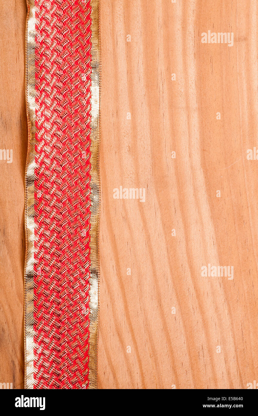 Wooden board with a red and golden ribbon Stock Photo - Alamy