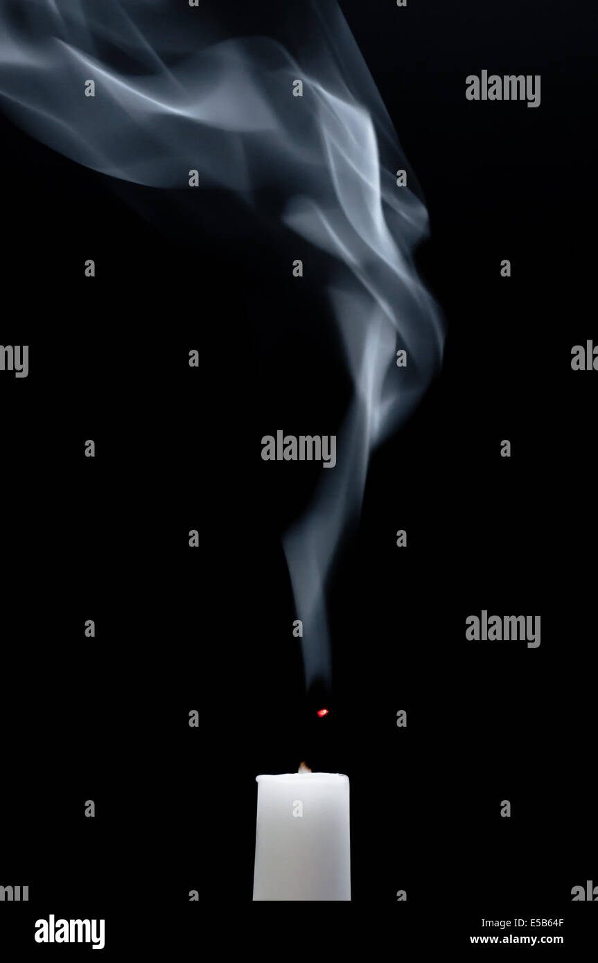 A white candle is smoking after it is extinguished Stock Photo Alamy