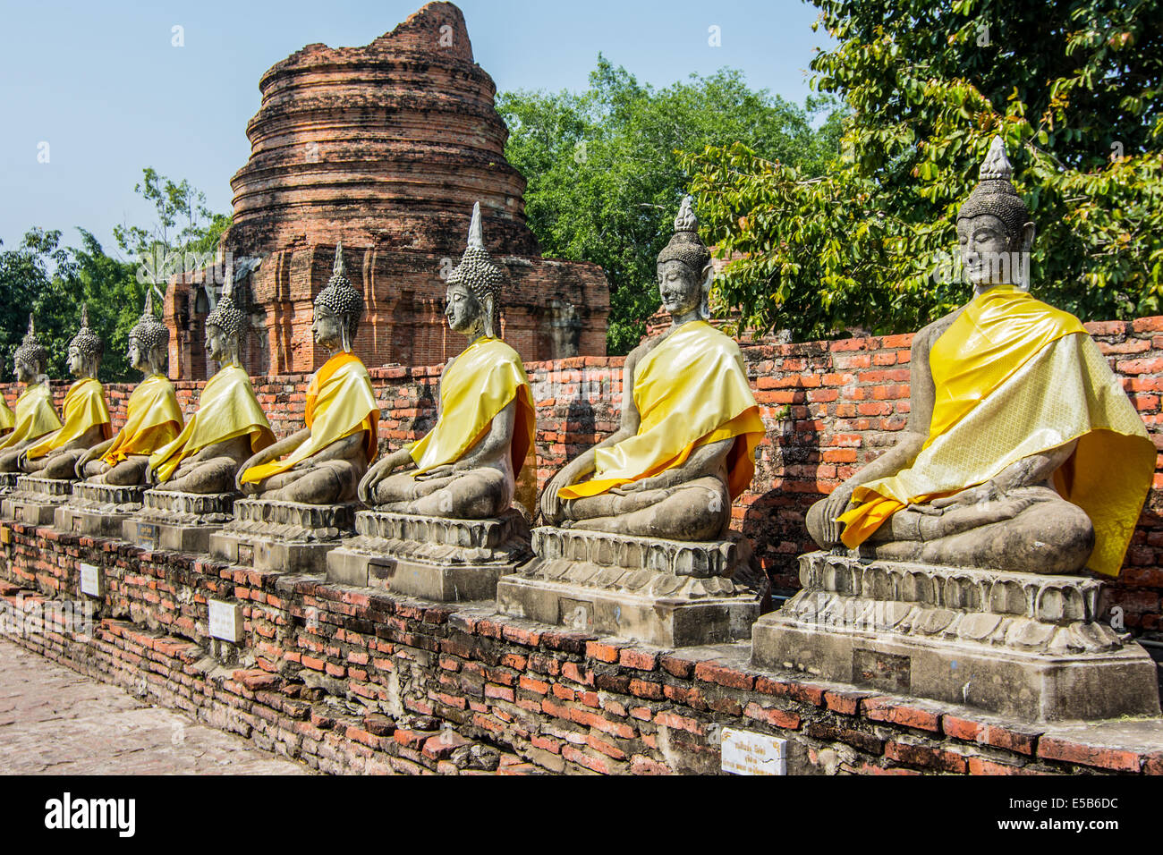 Row of ruined statue of buddha at Wat Yai Chaimongkol, Ayuthaya, Thailand. Stock Photo