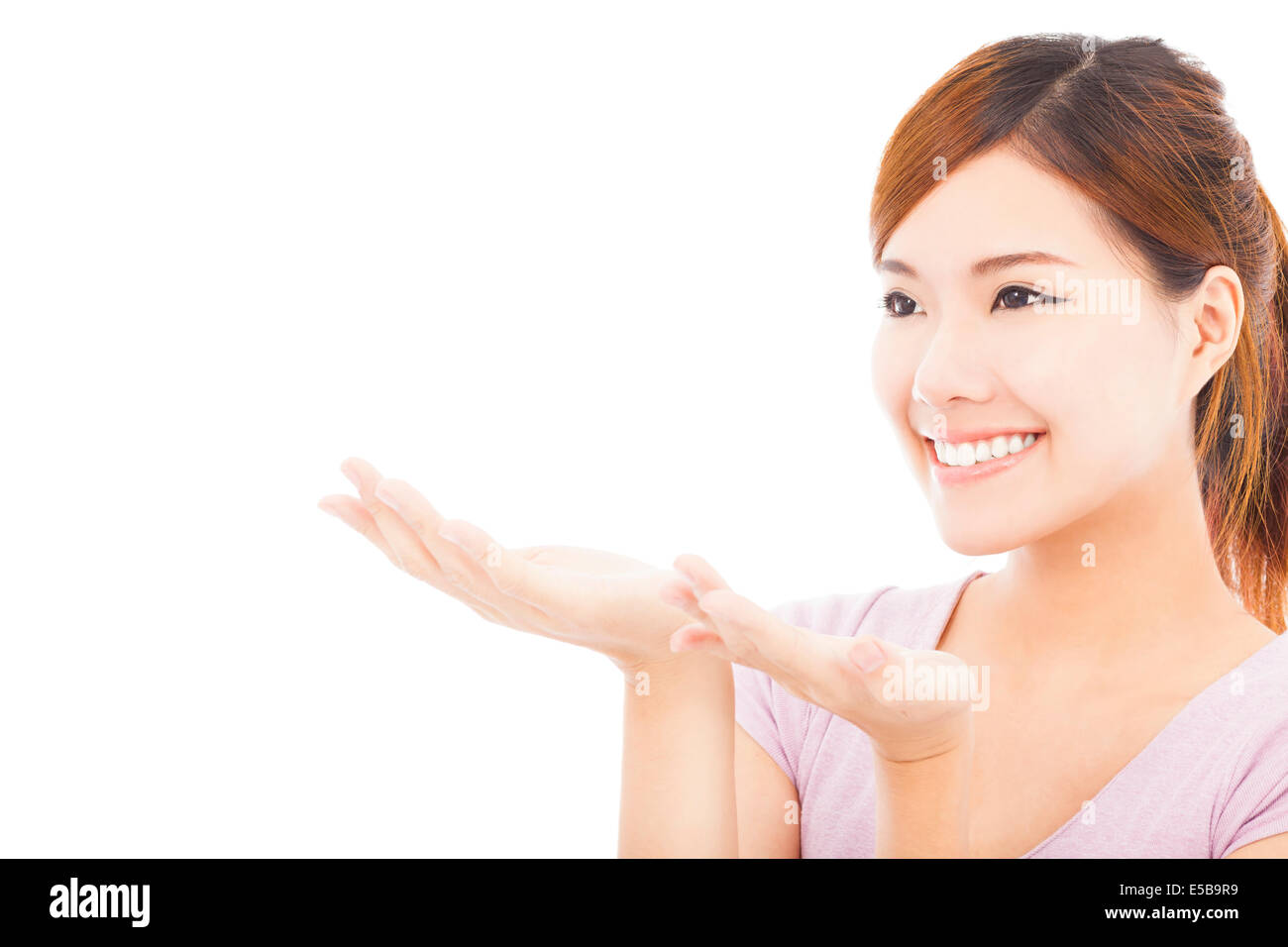 closeup of pretty woman looking the direction of hand gesture Stock Photo