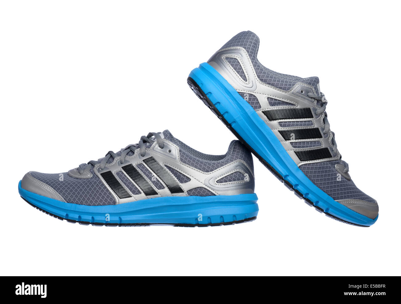 Lateral view of a pair of silver and blue Adidas running shoes cut out isolated on white background Stock Photo