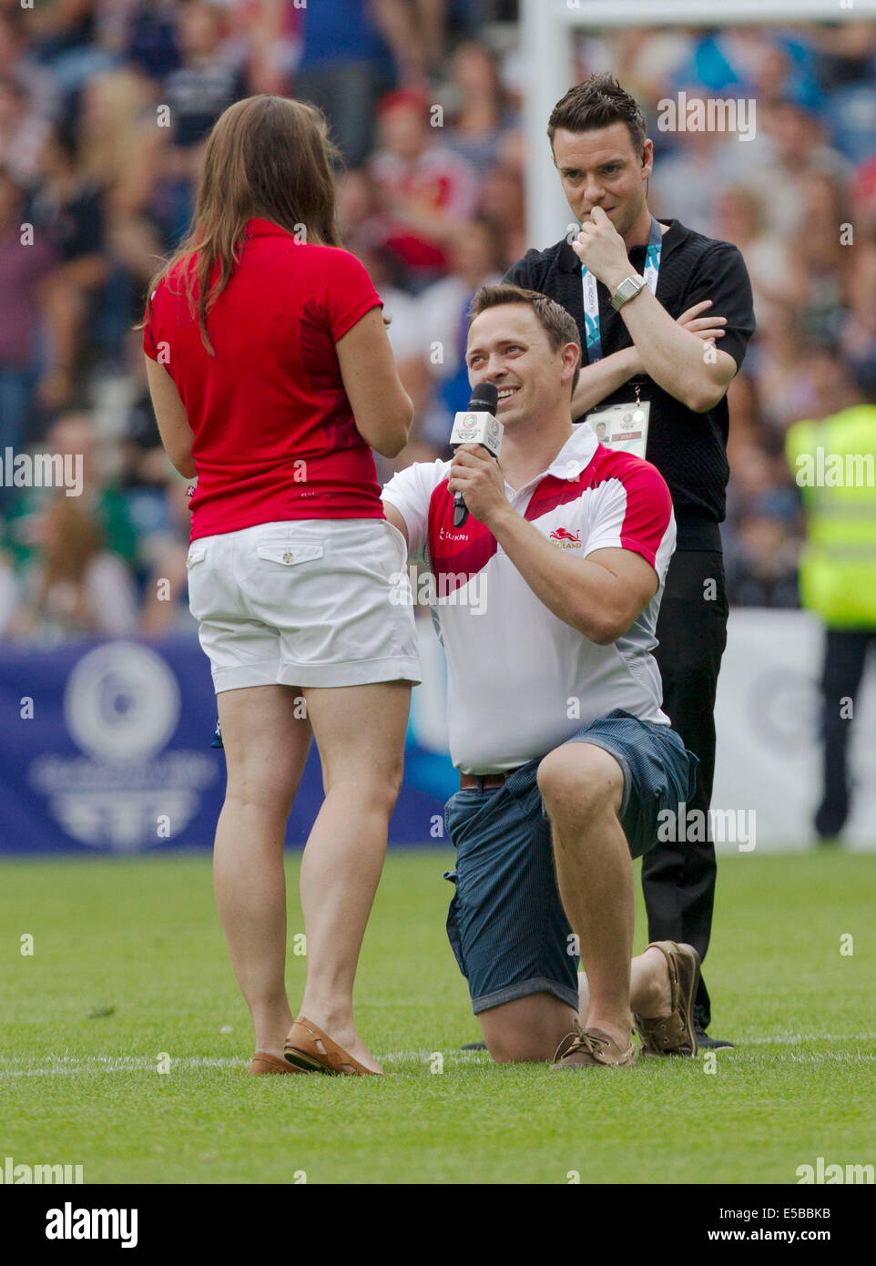 Glasgow, Scotland. 25th July, 2014. Glasgow Commonwealth Games. England fan proposes to his girlfriend on the field of play and she said Yes during The Rugby 7's from Ibrox Stadium. Credit:  Action Plus Sports/Alamy Live News Stock Photo