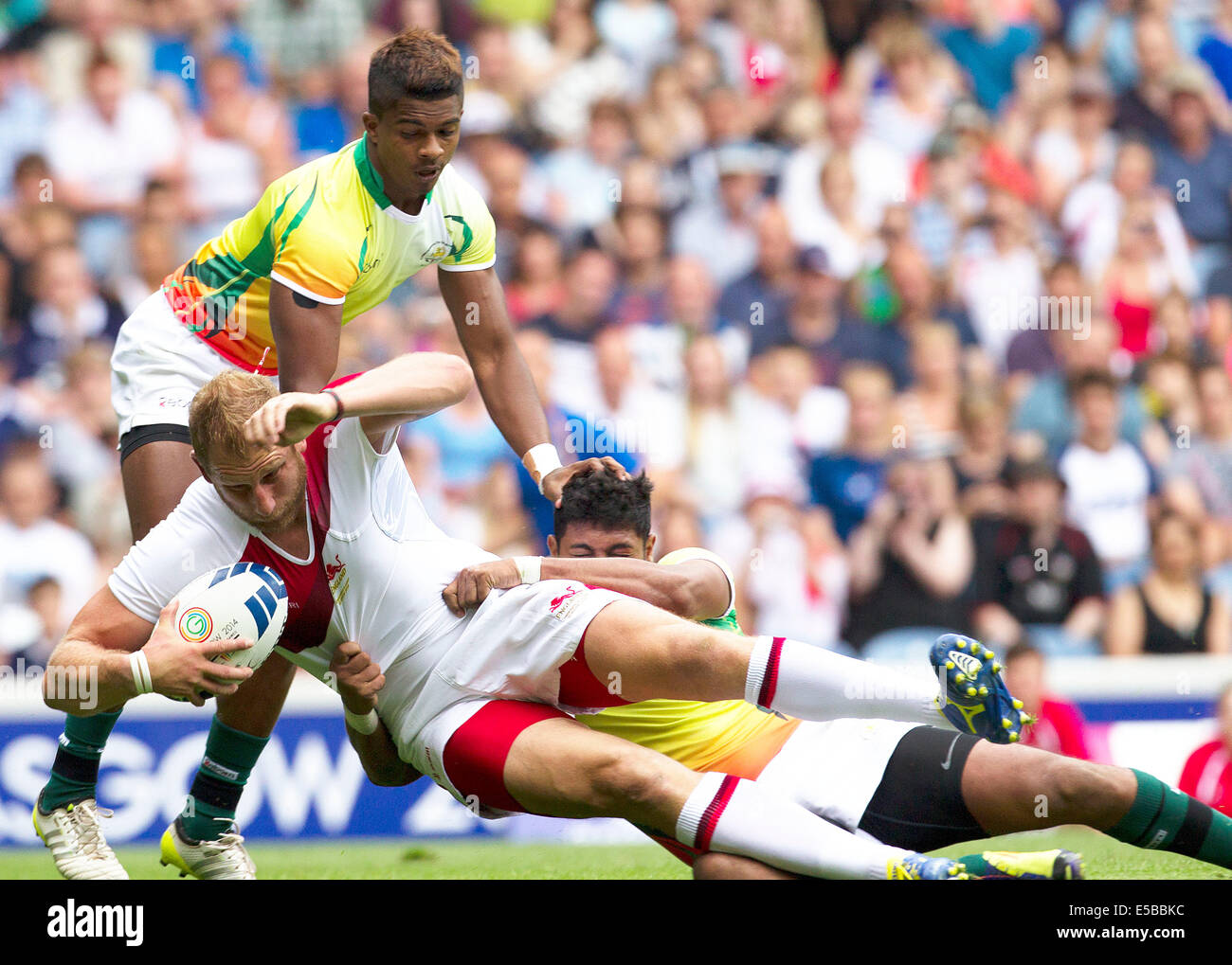 Glasgow, Scotland. 26th July, 2014. Glasgow Commonwealth Games. England's James Rodwell is tackled by Sri Lanka defence. England v Sri lanka in The Rugby 7's from Ibrox Stadium. Credit:  Action Plus Sports/Alamy Live News Stock Photo