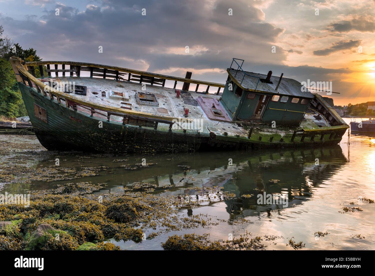 An old shipwrecked trawler on the shore at Plympton in Plymouth, Devon. Stock Photo