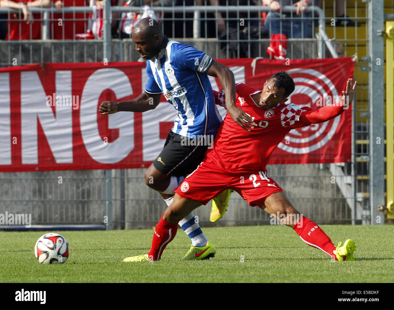 Duesseldorf's Sergio da Silva Pinto (R) vies for the ball with Wigan's Emmerson Boyce during the Fortuna Duesseldorf and Wigan Athletic in at Paul Janes Stadium in Duesseldorf, Germany, 26 July 2014. Photo: ROLAND WEIHRAUCH/dpa Stock Photo