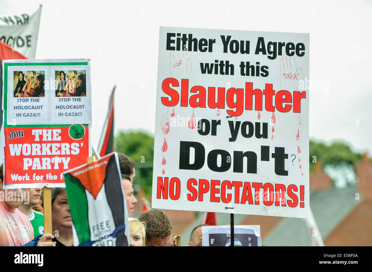 Belfast, Northern Ireland. 26 Jul 2014 - A protester holds up a poster saying 'Either you agree with this slaughter. Or you don't.  No spectators!' at a pro-Gaze/anti-Israeli protest rally Credit:  Stephen Barnes/Alamy Live News Stock Photo