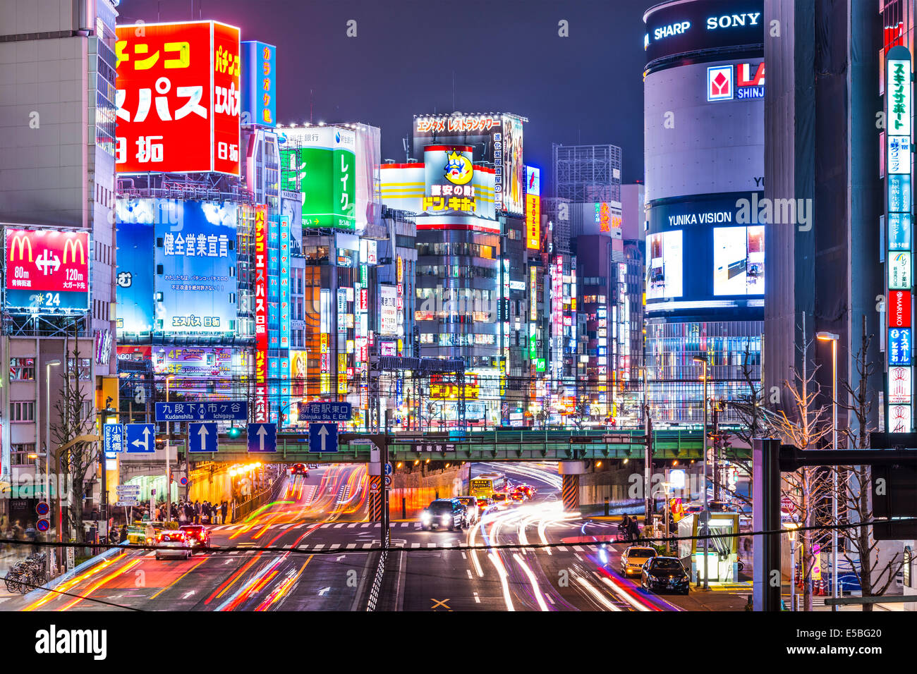 TOKYO, JAPAN - MARCH 19, 2014: Shinjuku district illuminated at night. The district is a renown night life center. Stock Photo