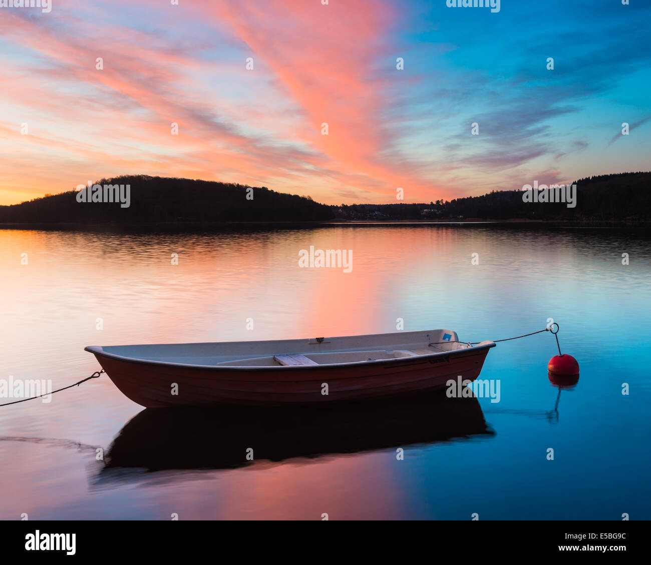 Reflection of moored boat on lake with dramatic sky Stock Photo - Alamy