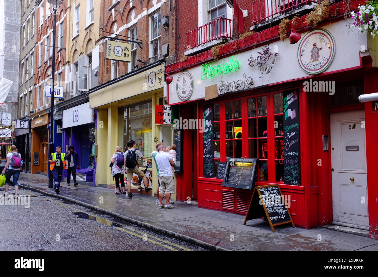 people looking at menus of restaurants in Soho, London Stock Photo