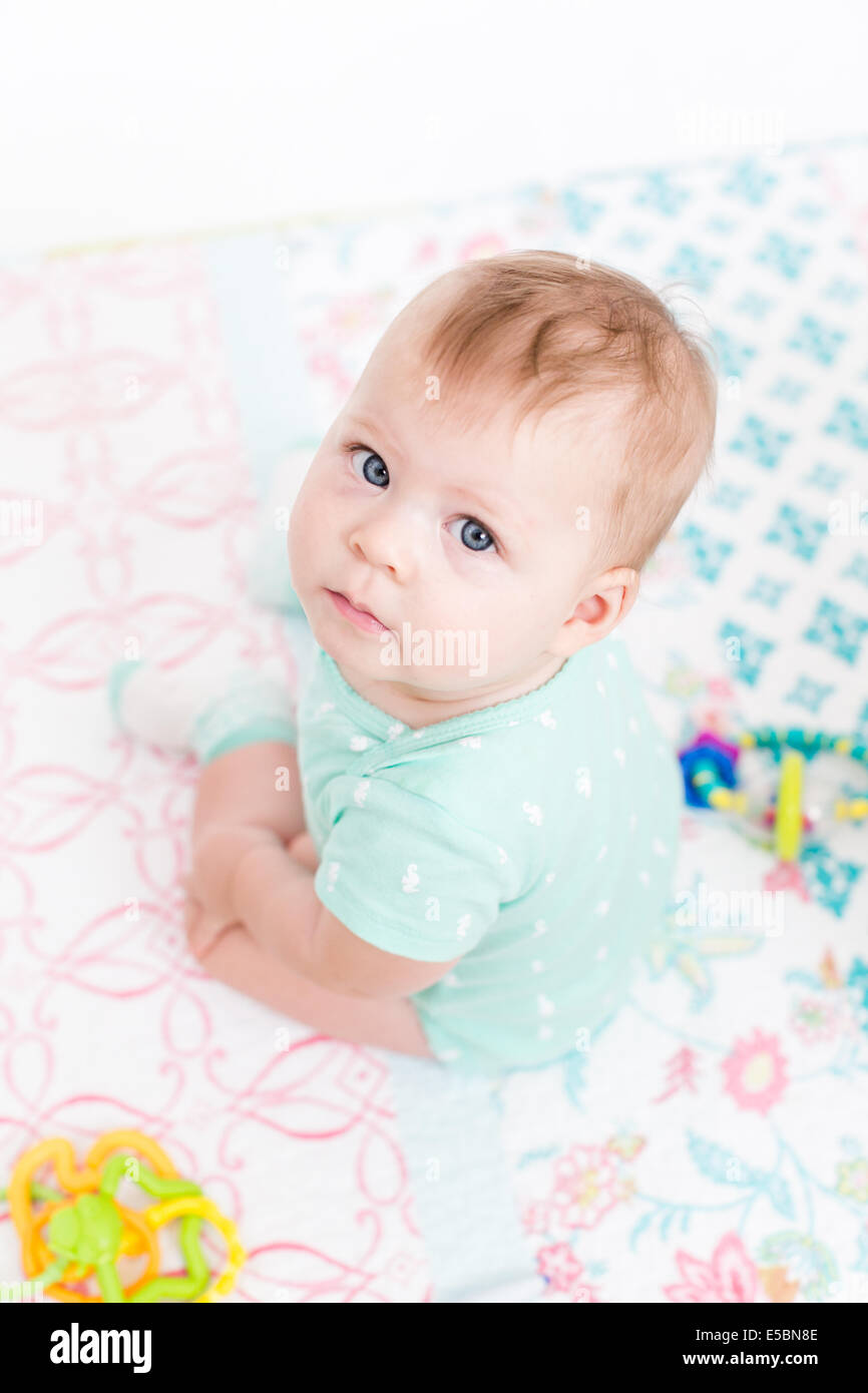 Cute baby girl playing with her toys on a blanket Stock Photo - Alamy