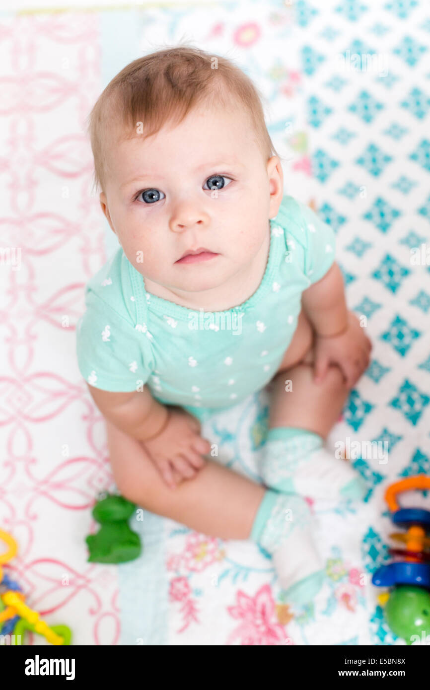 Cute baby girl playing with her toys on a blanket Stock Photo - Alamy