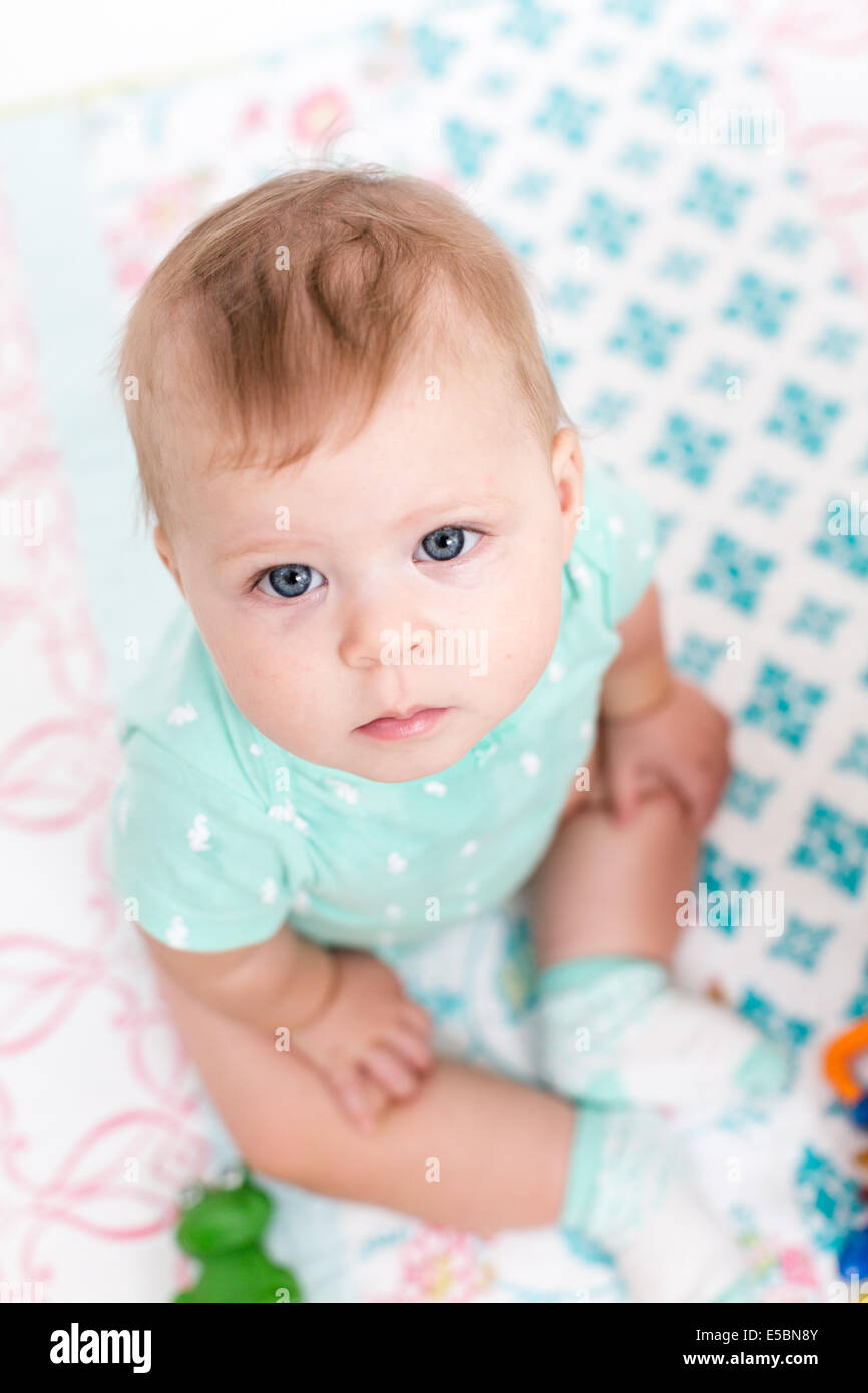Cute baby girl playing with her toys on a blanket Stock Photo - Alamy